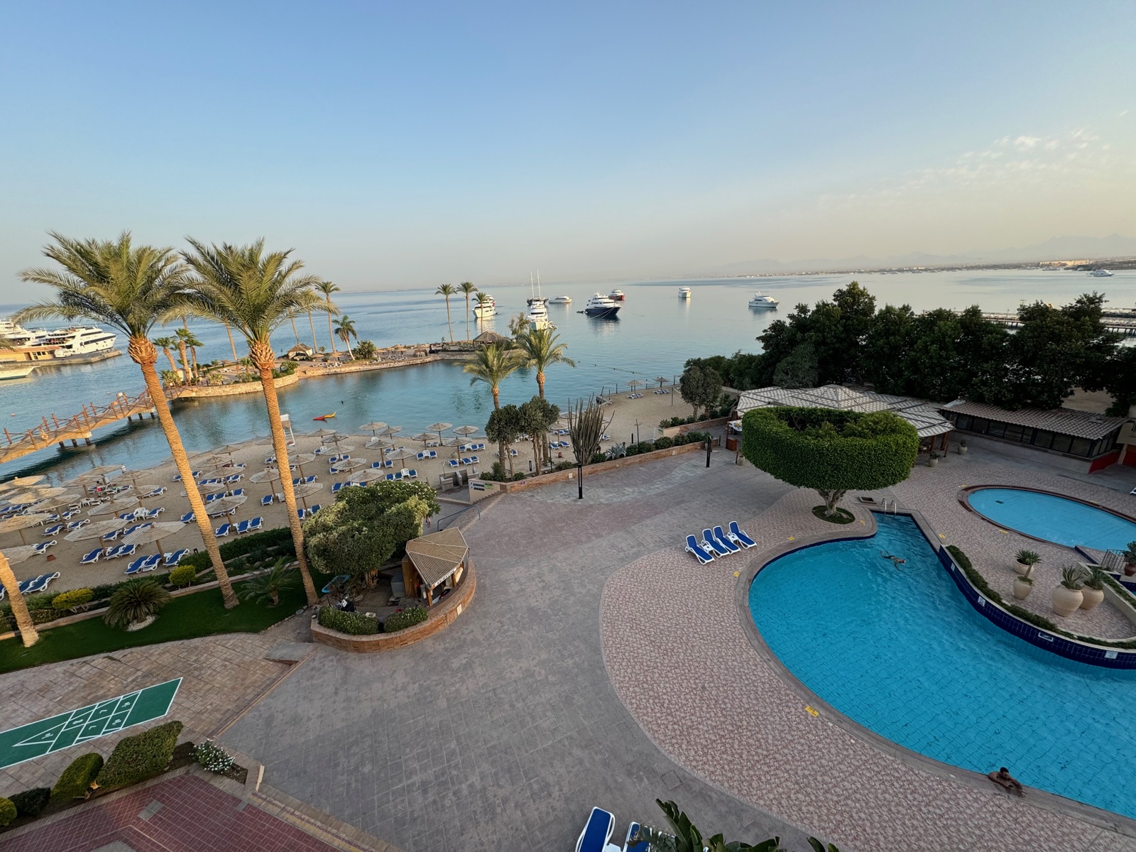 Palm trees and yachts around a resort marina on the Red Sea coast