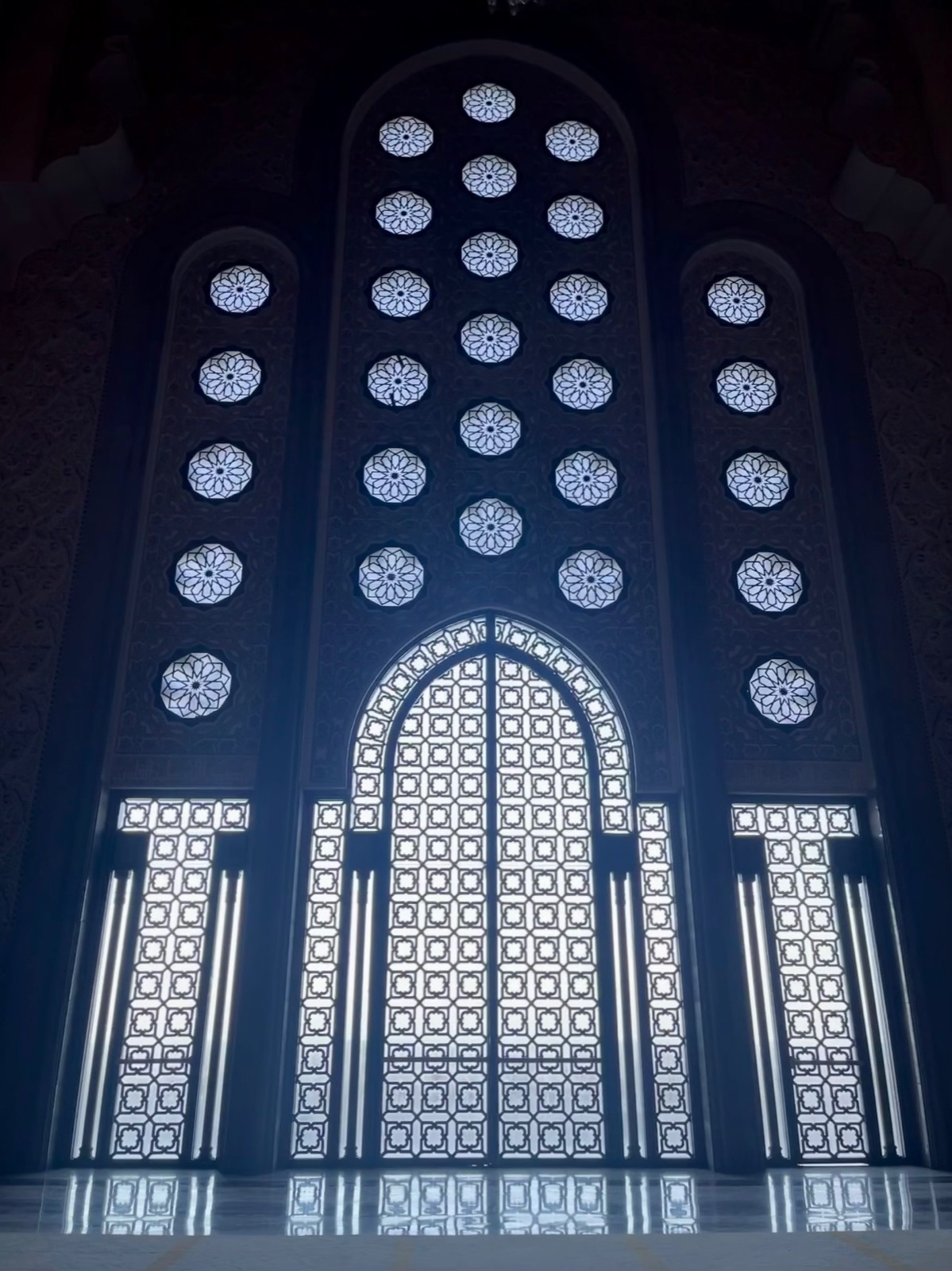 The carved doors and lantern-lit interior of the Hassan II Mosque